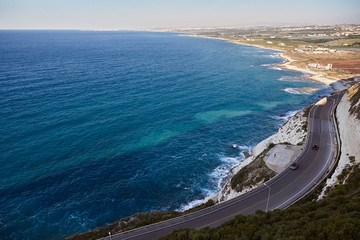 The Mediterranean sunny summer sea coast view of cliff road betw