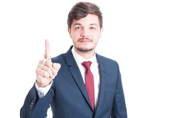 Real estate agent wearing suit holding key and rolling it