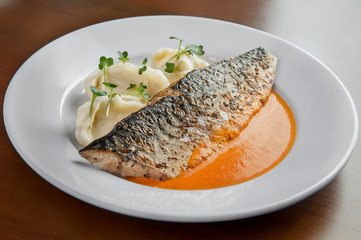 juicy fried mackerel with orange sauce and mashed potatoes lies