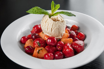 juicy caramelized fruit flambe with ice cream. Strawberry, cherr