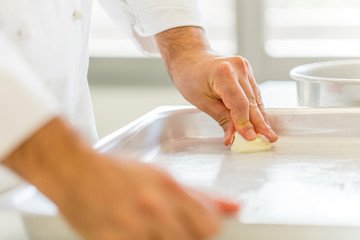 Obraz na płótnie Canvas chef's buttering the pan