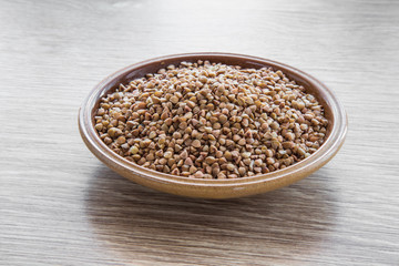 Buckwheat on the wooden board. Healthy eating and lifestyle.