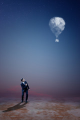 Businessman Standing and Looking at Cloud Balloons - Cloud Solution Concept