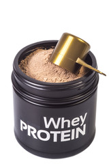 Black jar with whey caramel protein for fitness. Cap of the jar is opened and you can see  protein inside. Scoop full of protein above. Isolated on White background, close up image.