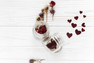 happy valentine day. stylish hearts in glass jar and roses flat