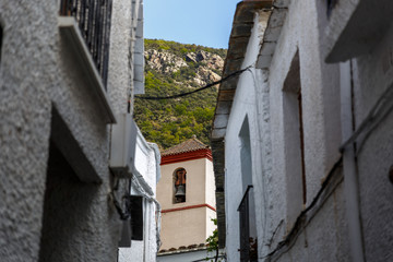 Fototapeta na wymiar View of a street and a bell tower of a village in the south of S