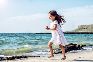 Happy little girl on the beach