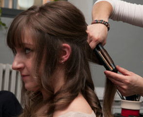 Fototapeta premium Ragazza si arriccia i capelli