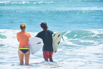 surf couple on a beach