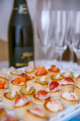 A wedding reception table with delicious appetizer and  bubbly drink