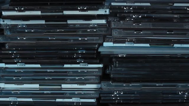 Empty and used DVD/CD boxes in the drawer. Background type of use.