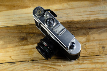 Old soviet rangefinder camera on a wooden table