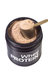 Black jar with whey caramel protein. Cap of the jar is opened and you can see  protein inside. Scoop full of protein above. Isolated on White background, close up image.