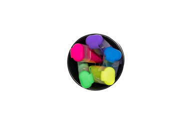 several colored highlighters in a round metal box. Top view
