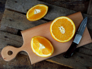 the composition of the cut orange on a wooden board. Selective focus
