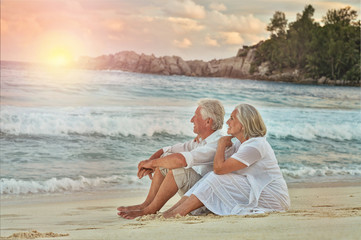 elderly couple rest at tropical beach