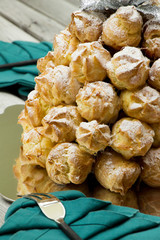 French dessert croquembouche. Wedding cake. New year dessert. Homemade eclairs filled with custard. Profiterole. 