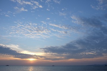 sunset from beach with cloudy blue sky