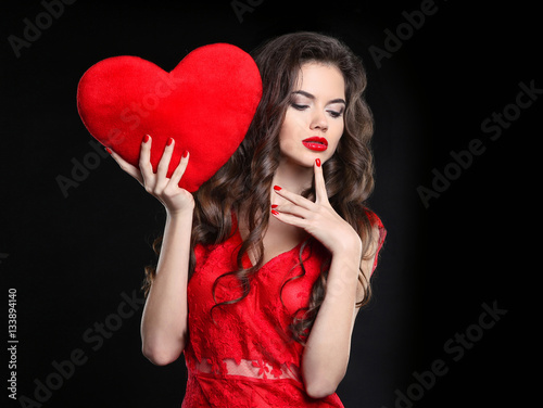 "Beautiful girl with valentine heart. Sexy brunette woman posing" photo