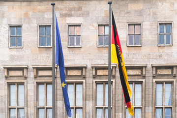 Berlin, Germany - January 18, 2017: Flags of Federal Republic of Germany and of European Union waving in front of Federal Ministry of Finance in Berlin