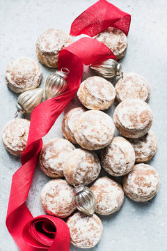 Overhead view of Christmas baubles, red ribbon with fresh scones
