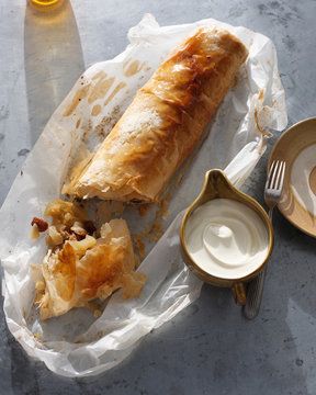 Bistro dessert of apple strudel and cream on table