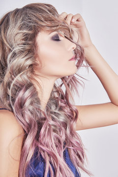 Girl with colored healthy hair.sexy young woman with curly trendy beauty salon hairstyle