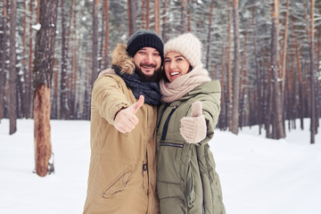 Fototapeta premium Elated couple holding thumbs up expressing the happiness