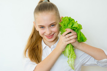 Happy fitness girl holding lettuce isolated