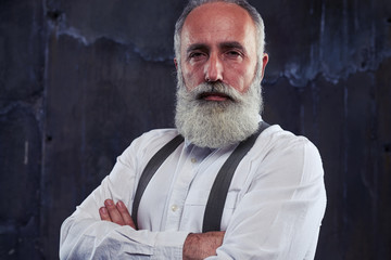 Man with deep look posing at the camera isolated over black back