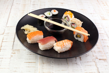 close up of sashimi sushi set with chopsticks and soy - sushi roll with salmon and sushi roll with smoked eel, selective focus.