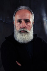 Portrait of handsome mature bearded man looking at the camera