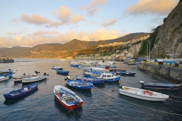View of Scilla at dusk with harbor and small boats, Strait of Messina, Calabria, Italy