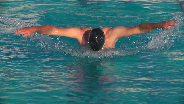 Swimmer performing Butterfly towards Camera