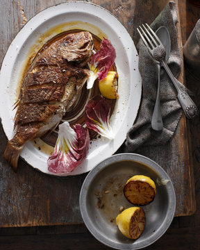 Whole grilled snapper on serving tray
