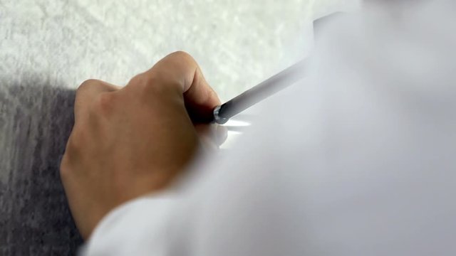 A young woman is putting a screw in a hole and she is attaching it with a screwdriver.
