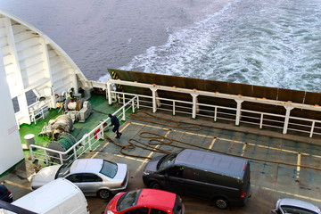 workers on the ferry with cars, view from above