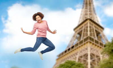 happy african american woman jumping over white