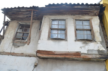 old house made of wood and stone with broken windows 