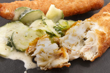 fried haddock and fresh cucumber salad on slate