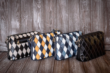 group leather bag on brown wooden background.