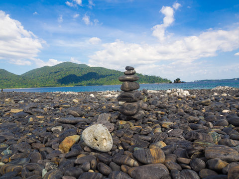 Balance stone on sea beach mountain background
