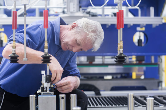 Engineer working on electrical component controls in engineering plant