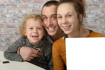 happy family, the mom holding a white sheet of paper