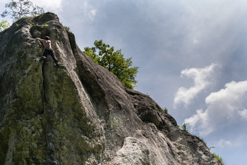 Men climbing vertical wall, Poland