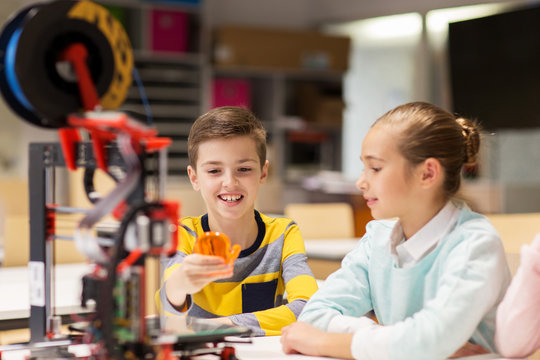 happy children with 3d printer at robotics school