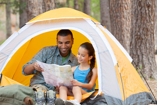 Young man and girl in dome tent looking at map, Sedona, Arizona, USA
