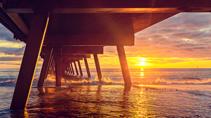 Dramatic sunset view from under pier