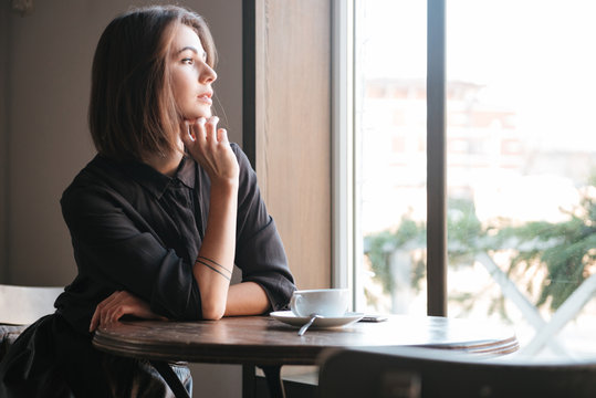 Premium Photo  Pensive woman sitting at table while thinking