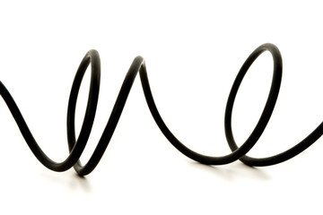 Curled shaped black wire cable on a white background